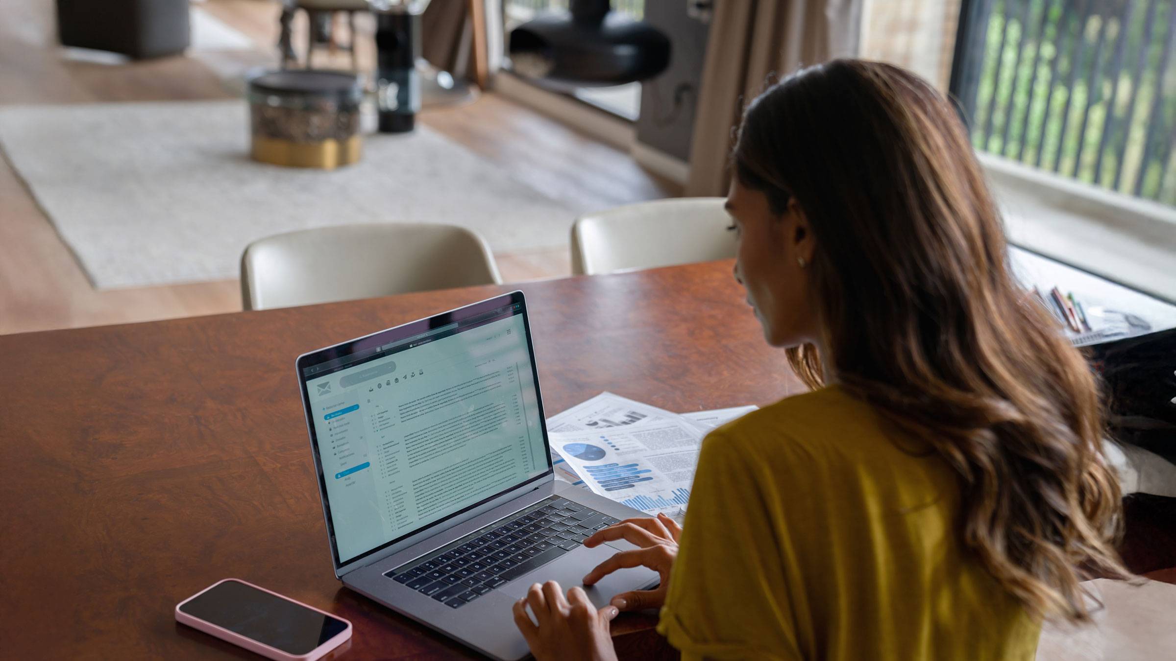 Woman working at home on her laptop computer and checking her email account