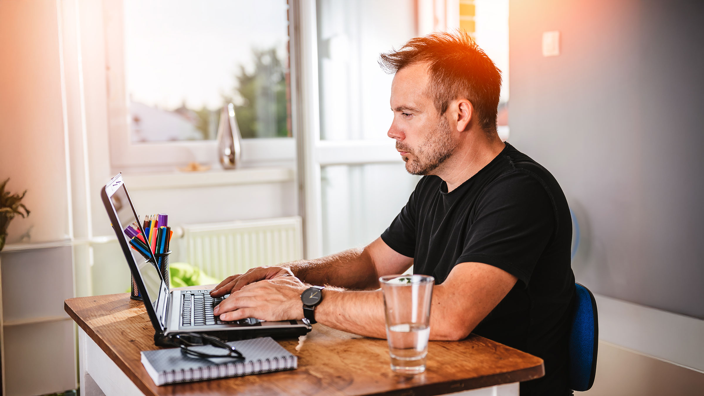Man working on laptop in home office