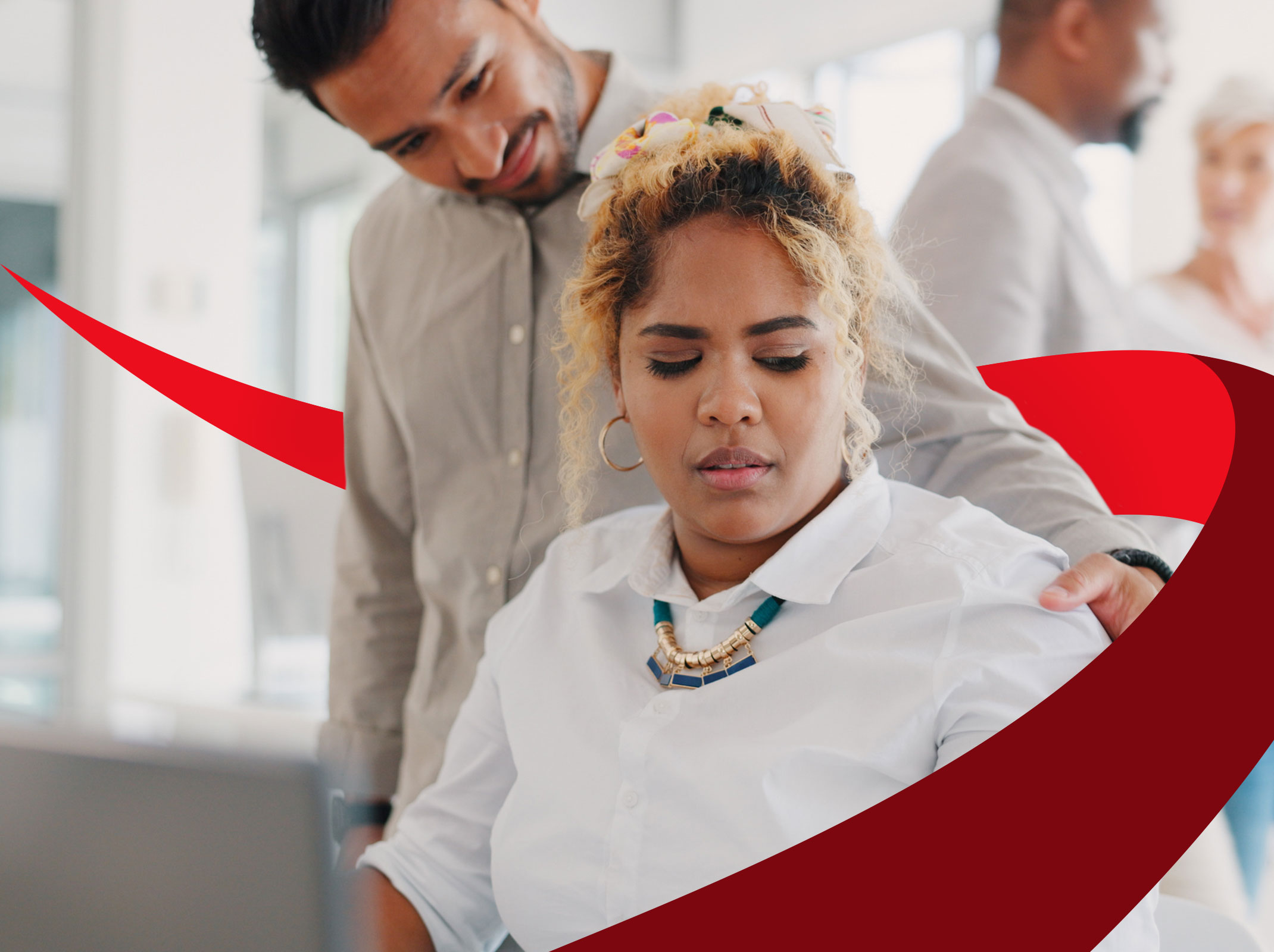 A business professional in an office setting looking uncomfortable as a coworker touches her shoulder.