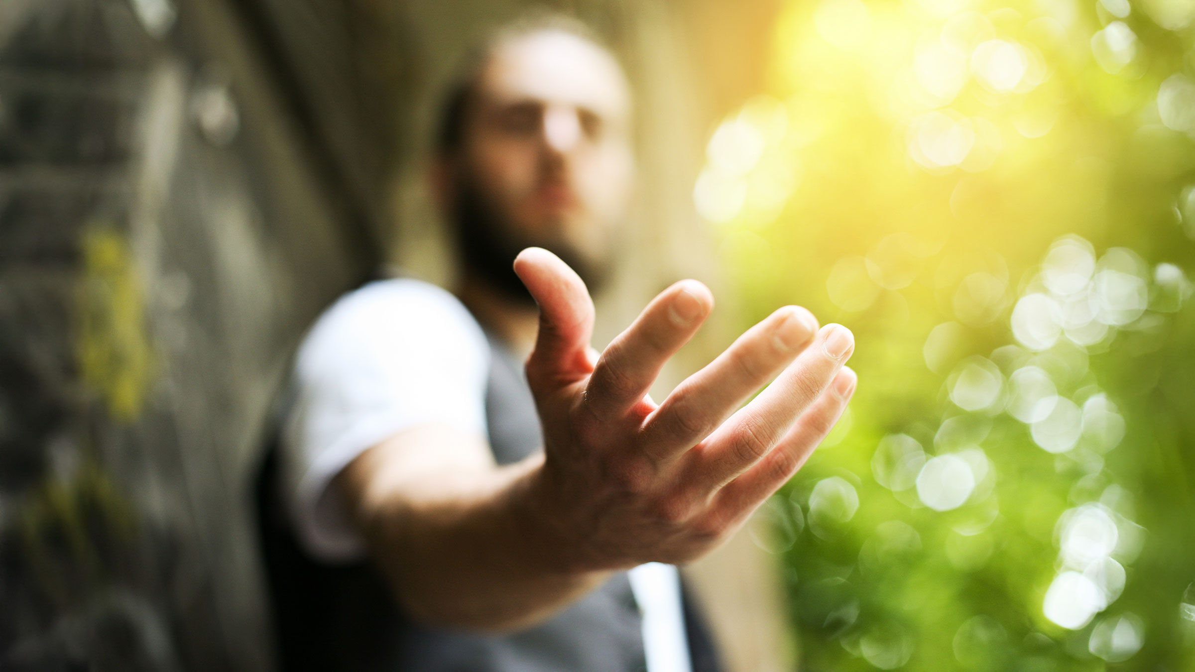 Giving a helping hand, offering help close-up shot of a man in a business attire.