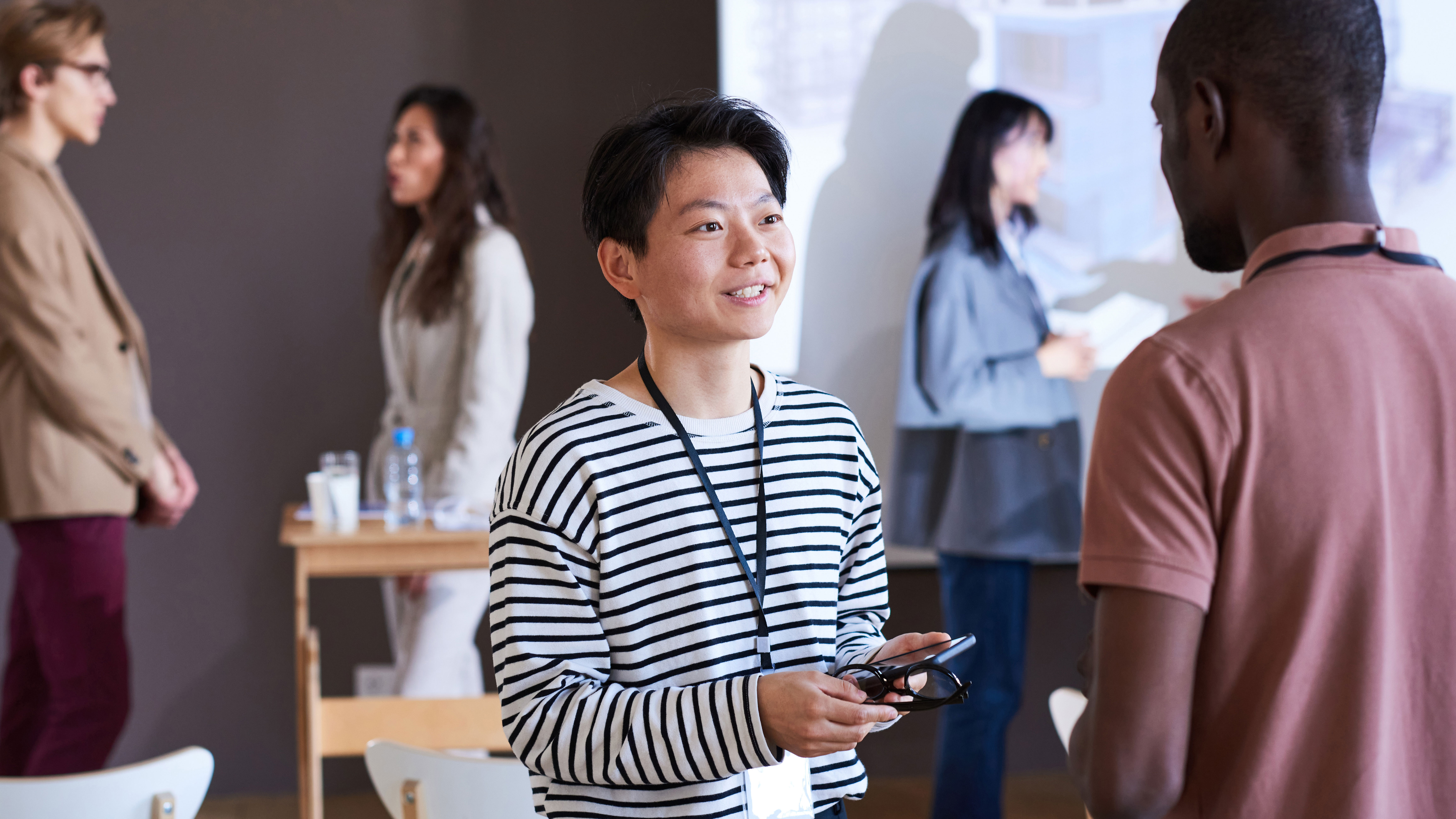 Young woman talking with the man at seminar