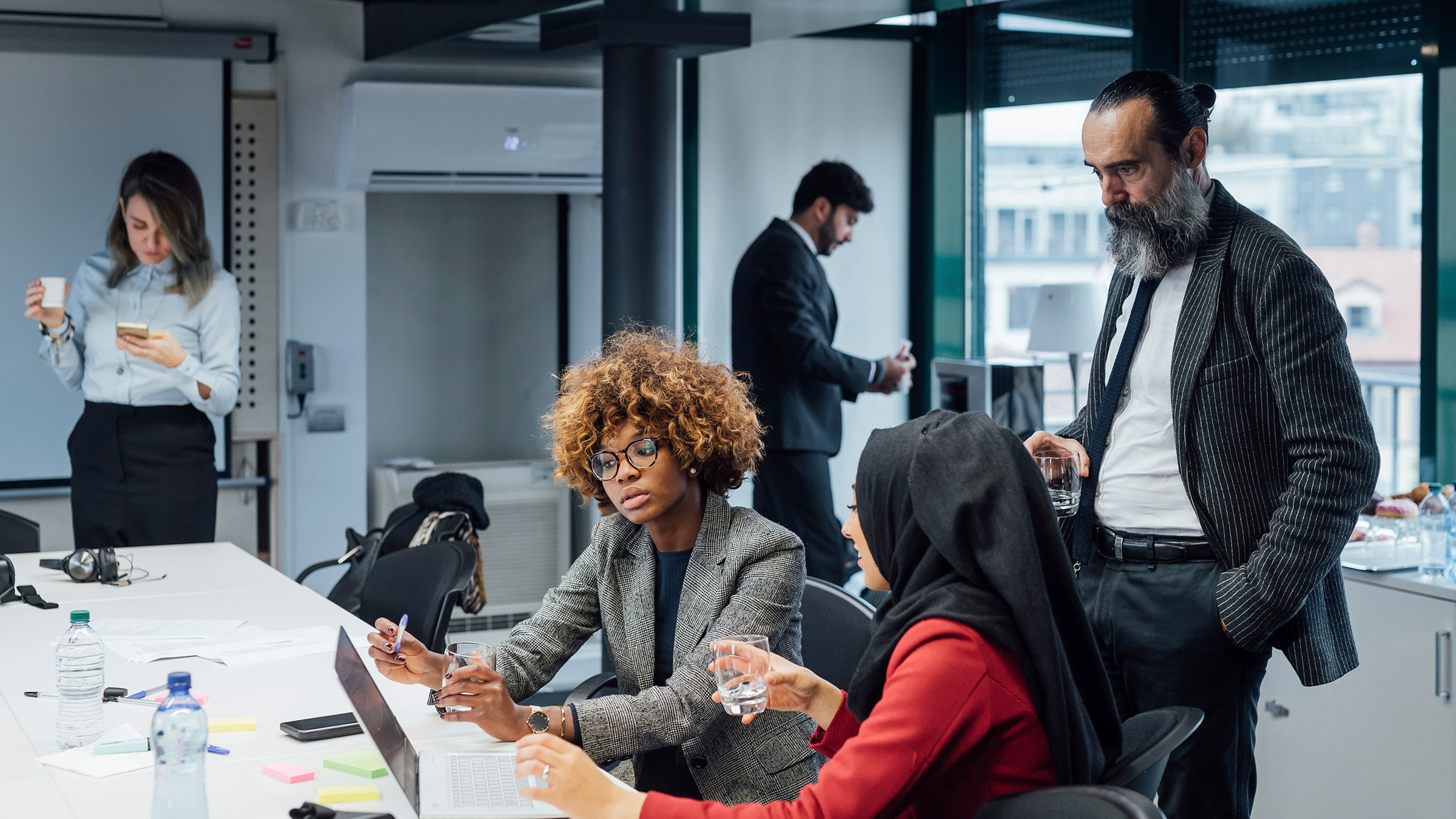 Group of coworkers looking at computer in office