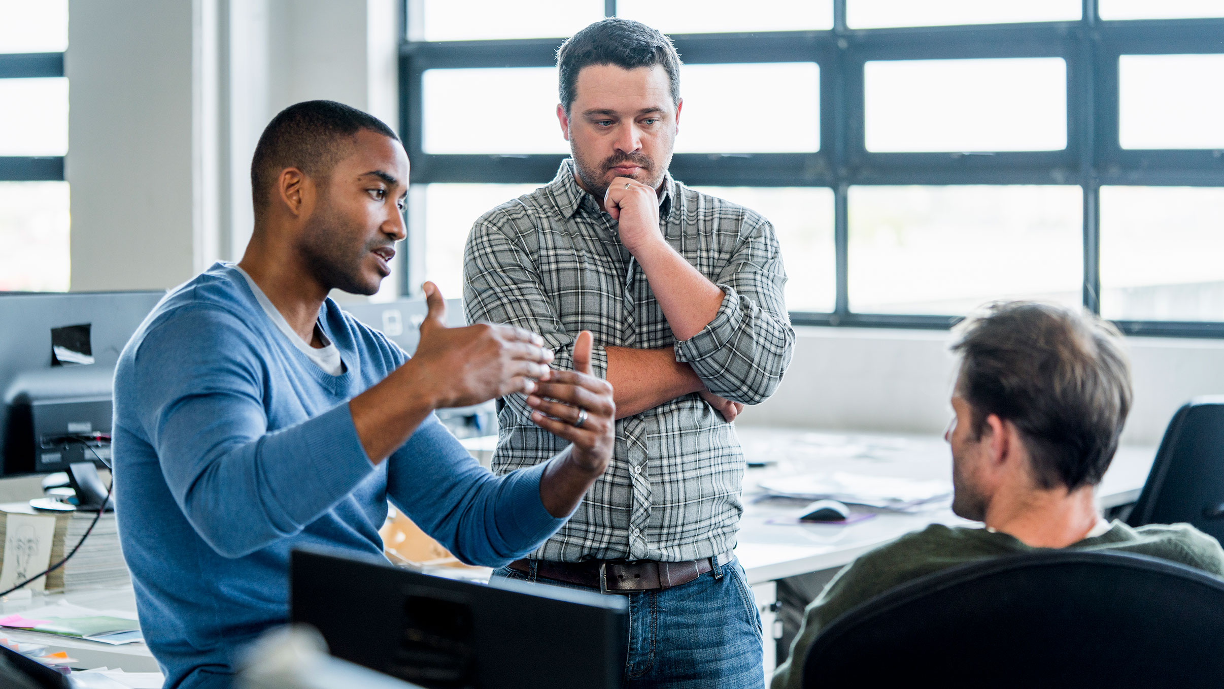 Businessmen discussing in creative office