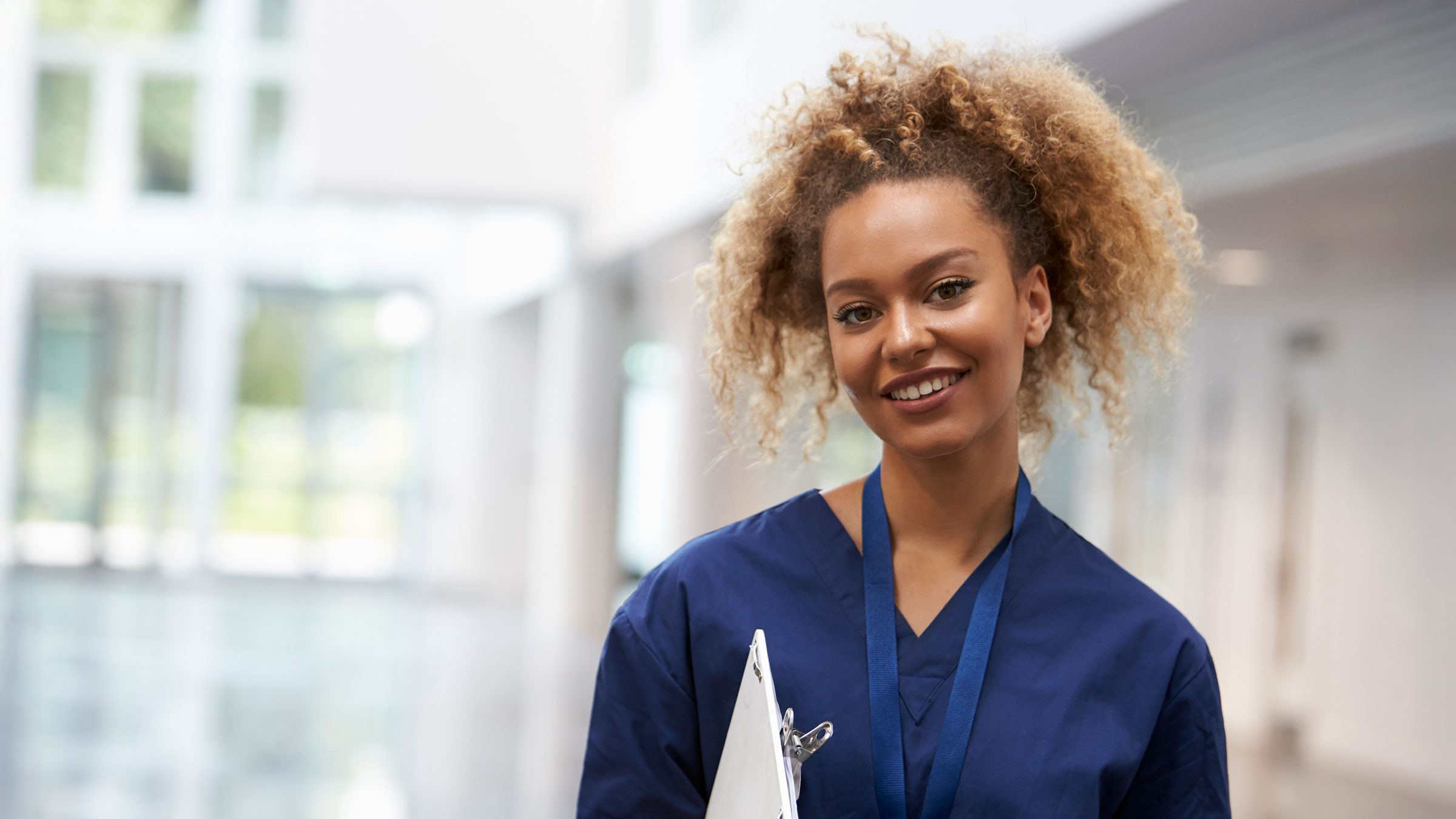 Portrait of female nurse wearing scrubs in hospital