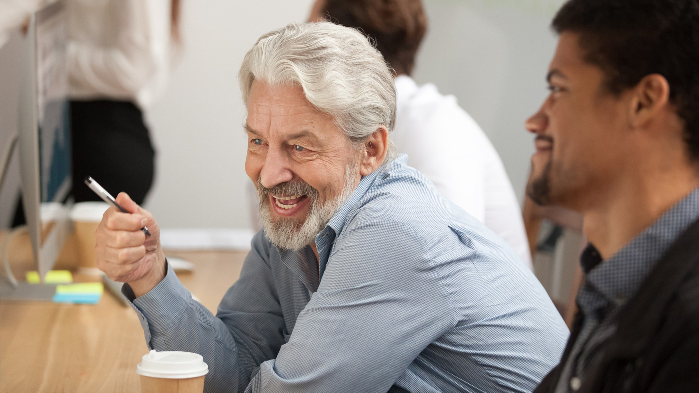 Multi-generational businessmen working together
