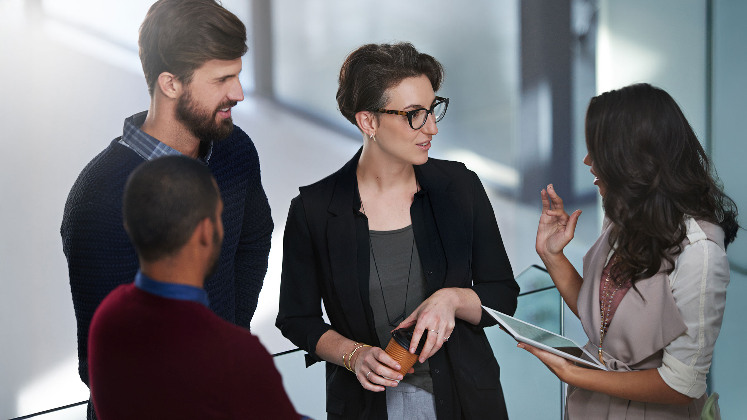 Young woman sharing ideas with manager and colleagues