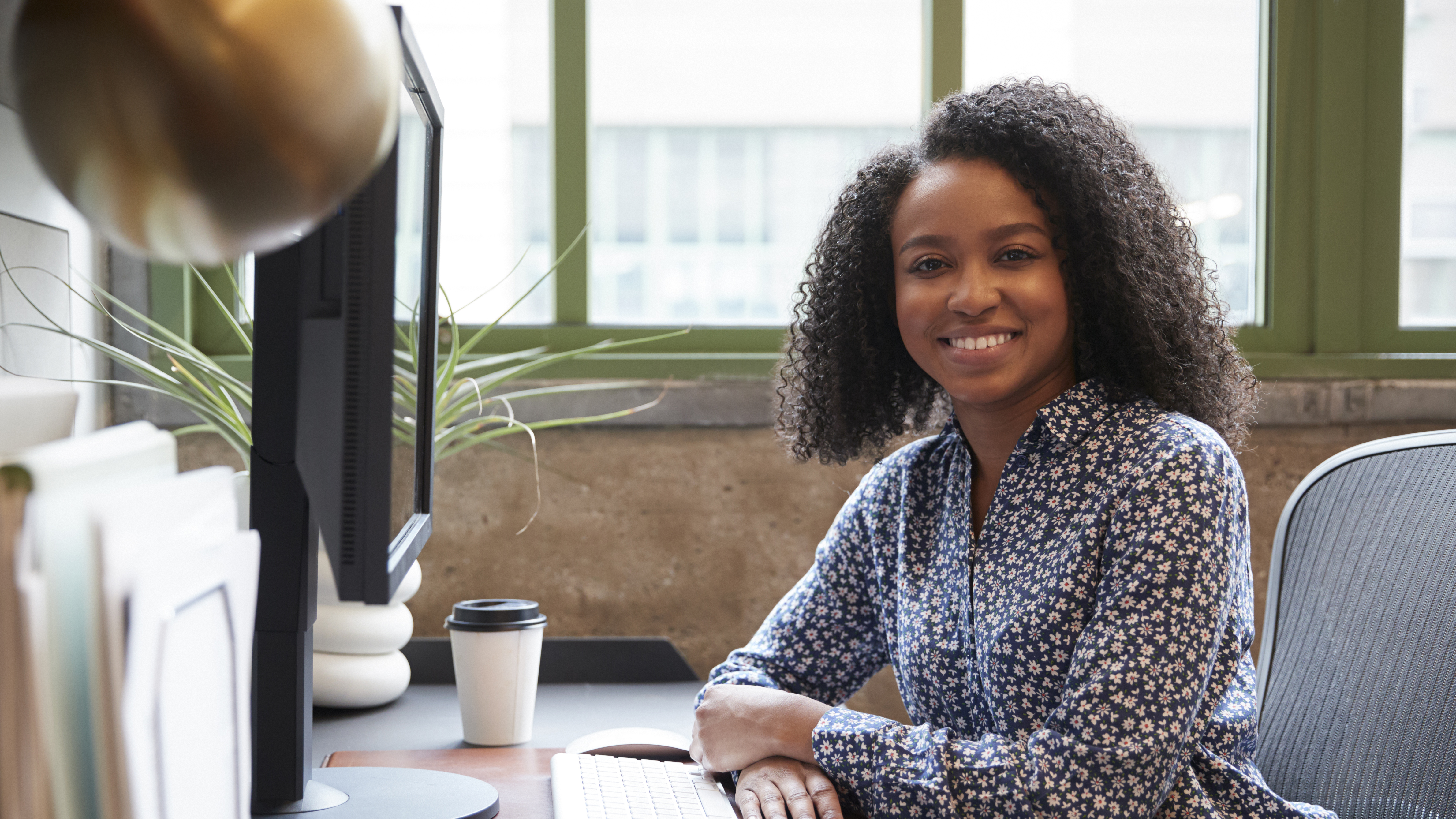 Woman smiling at a desk