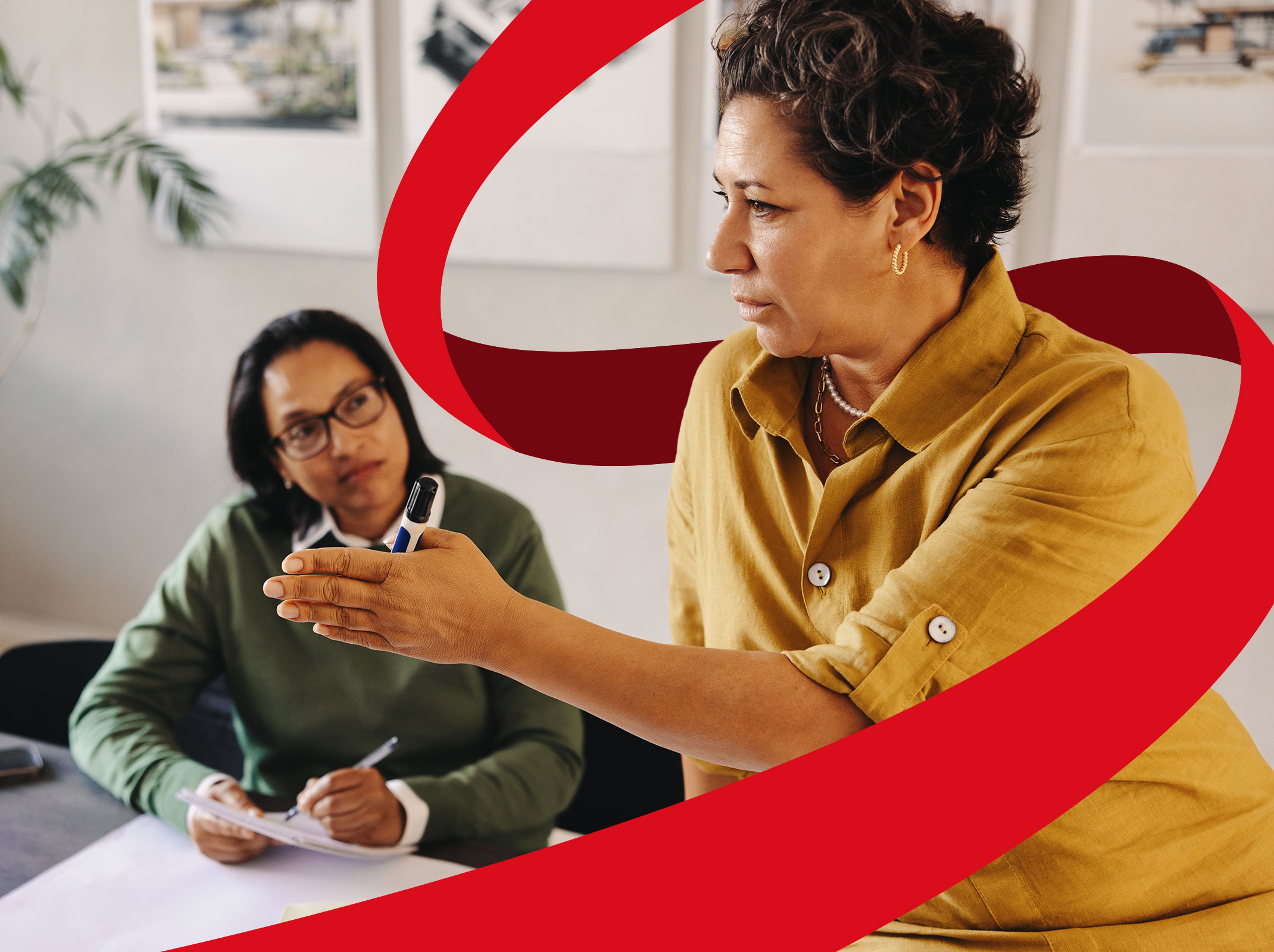 Manager giving instructions or delegating work to her employee during a meeting