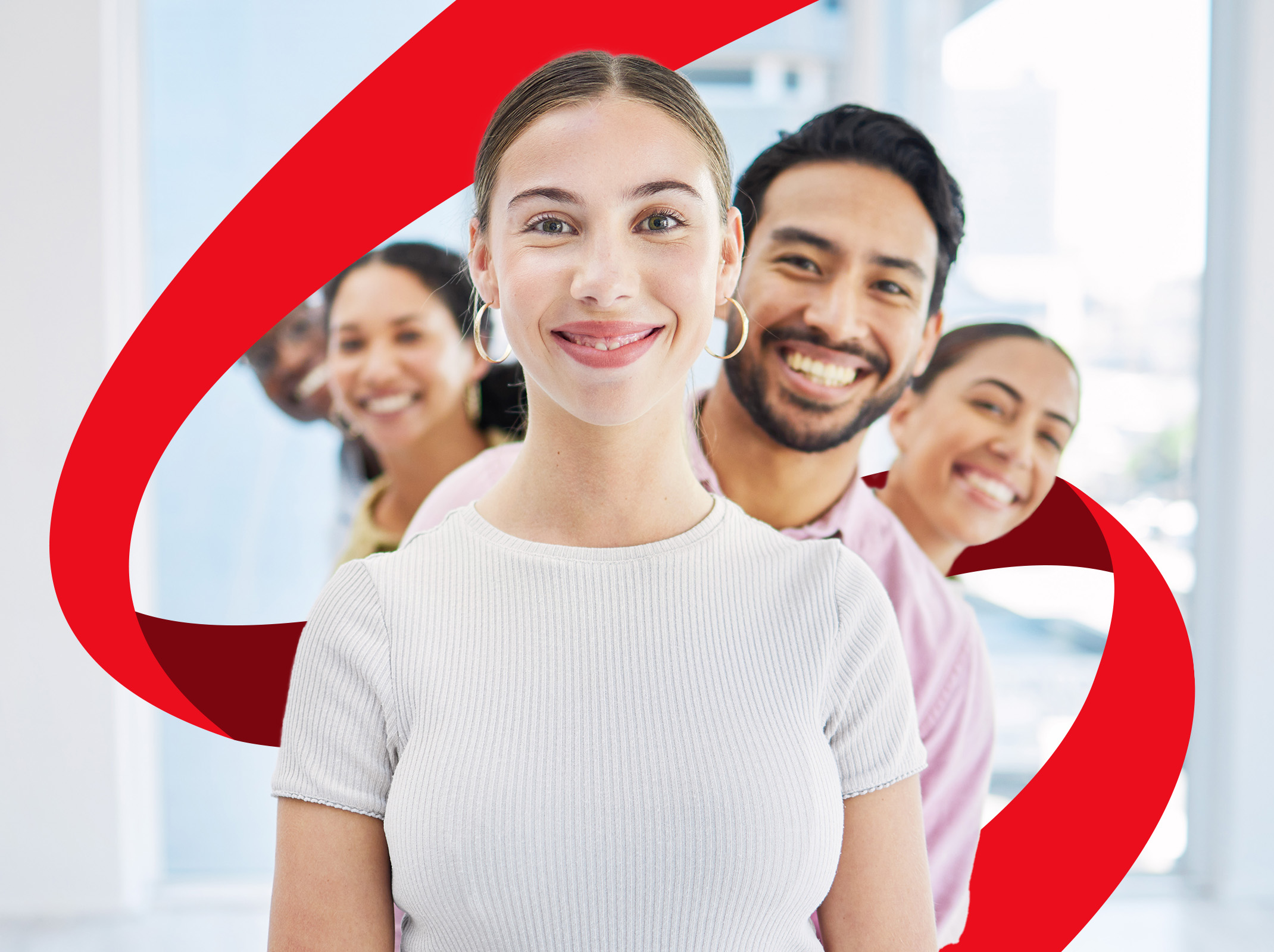 Diverse group of smiling professionals in modern office, overcoming workplace negativity with resonant positivity.