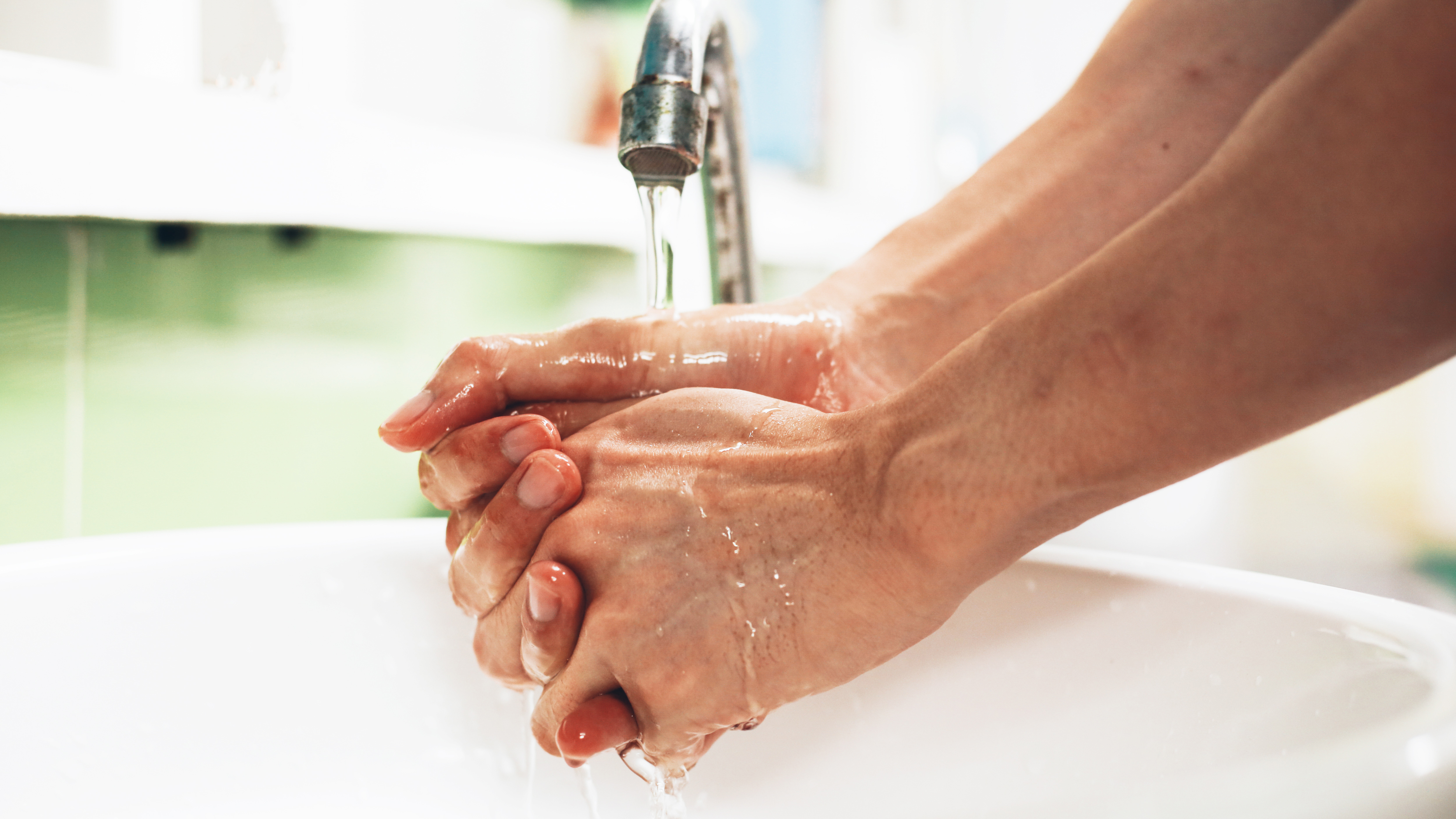 Close of photo of someone washing their hands