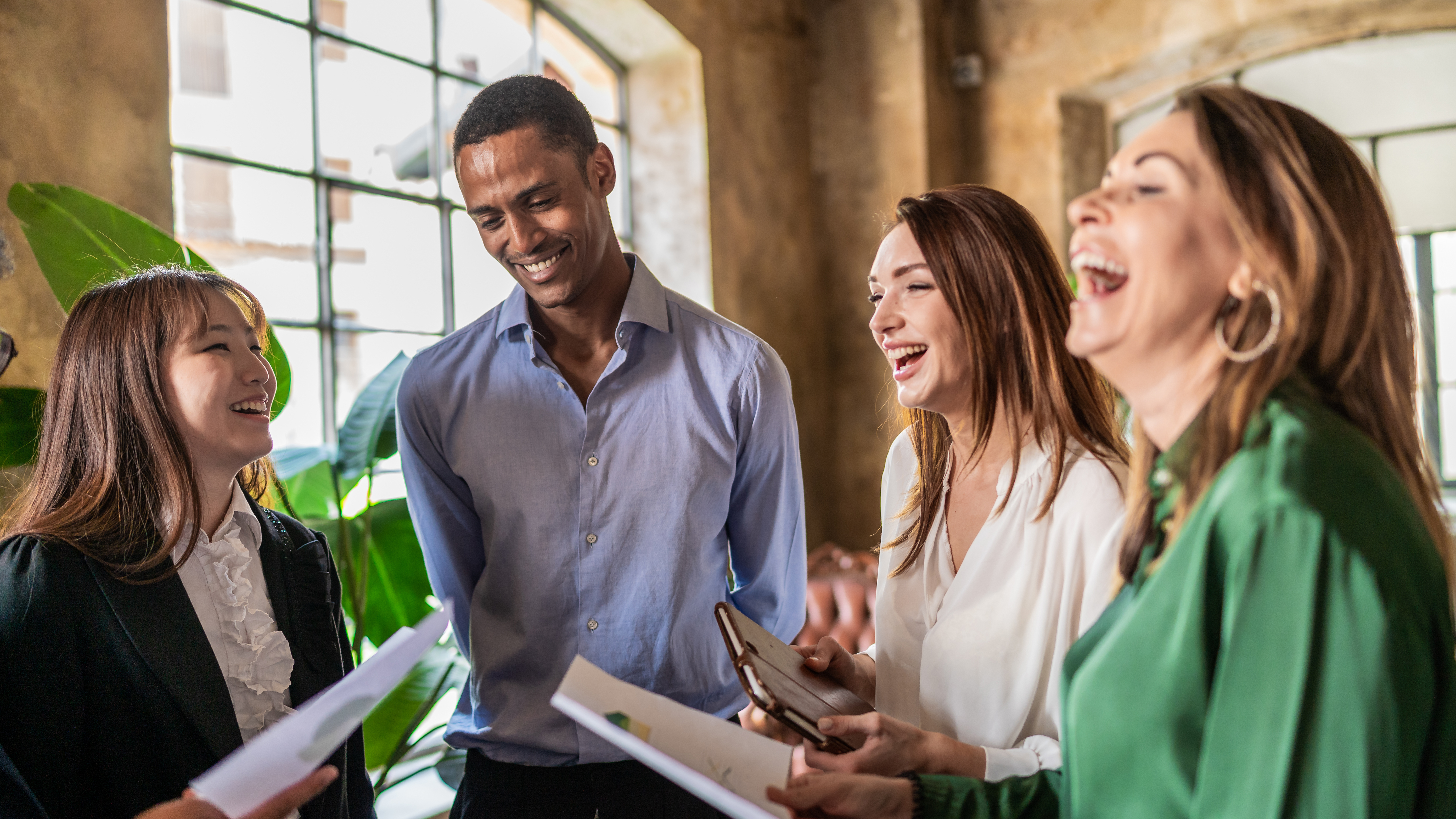 A group of coworkers laughing during a meeting