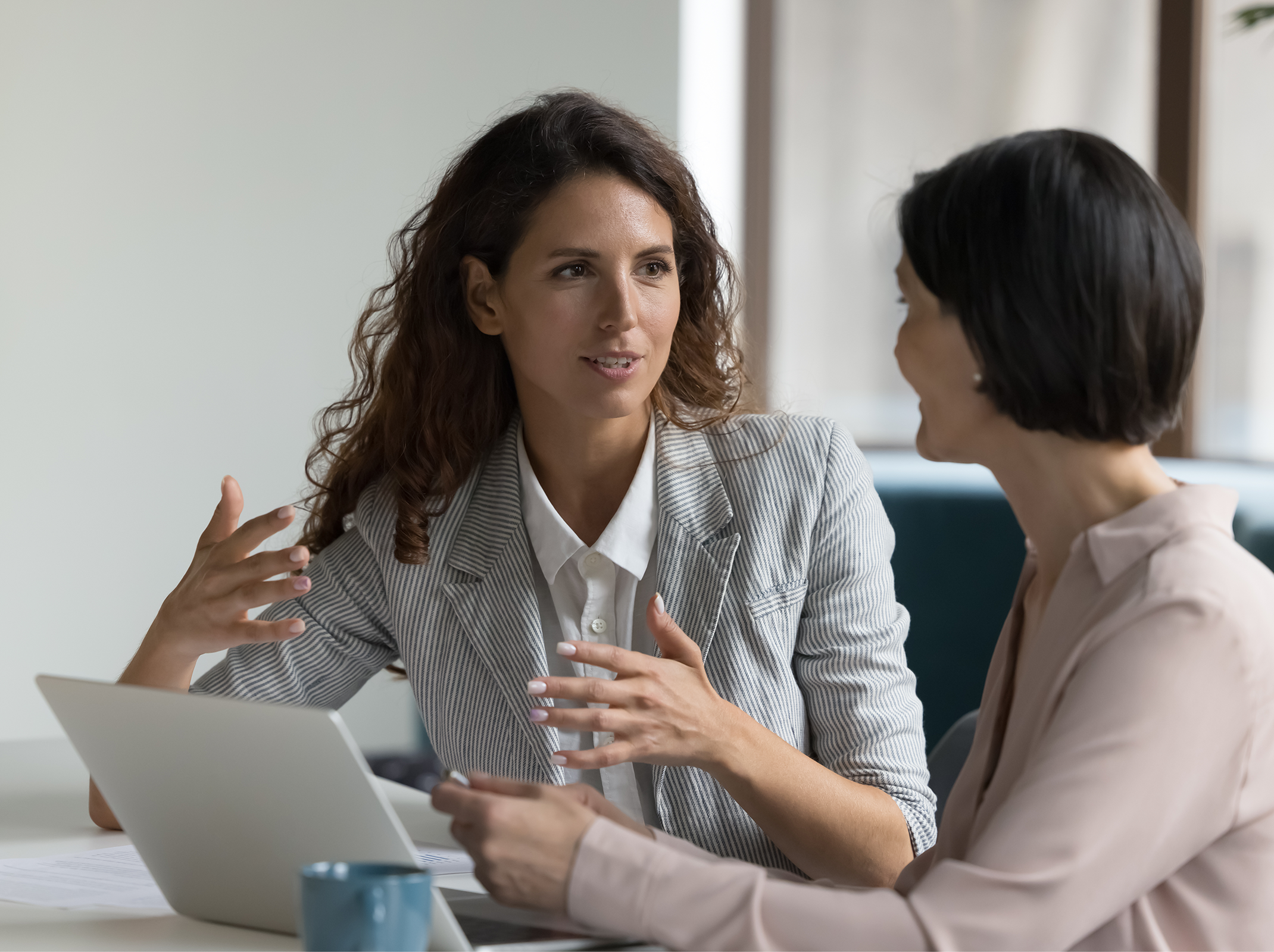 Two professionals collaborating on workplace decisions and team strategy.