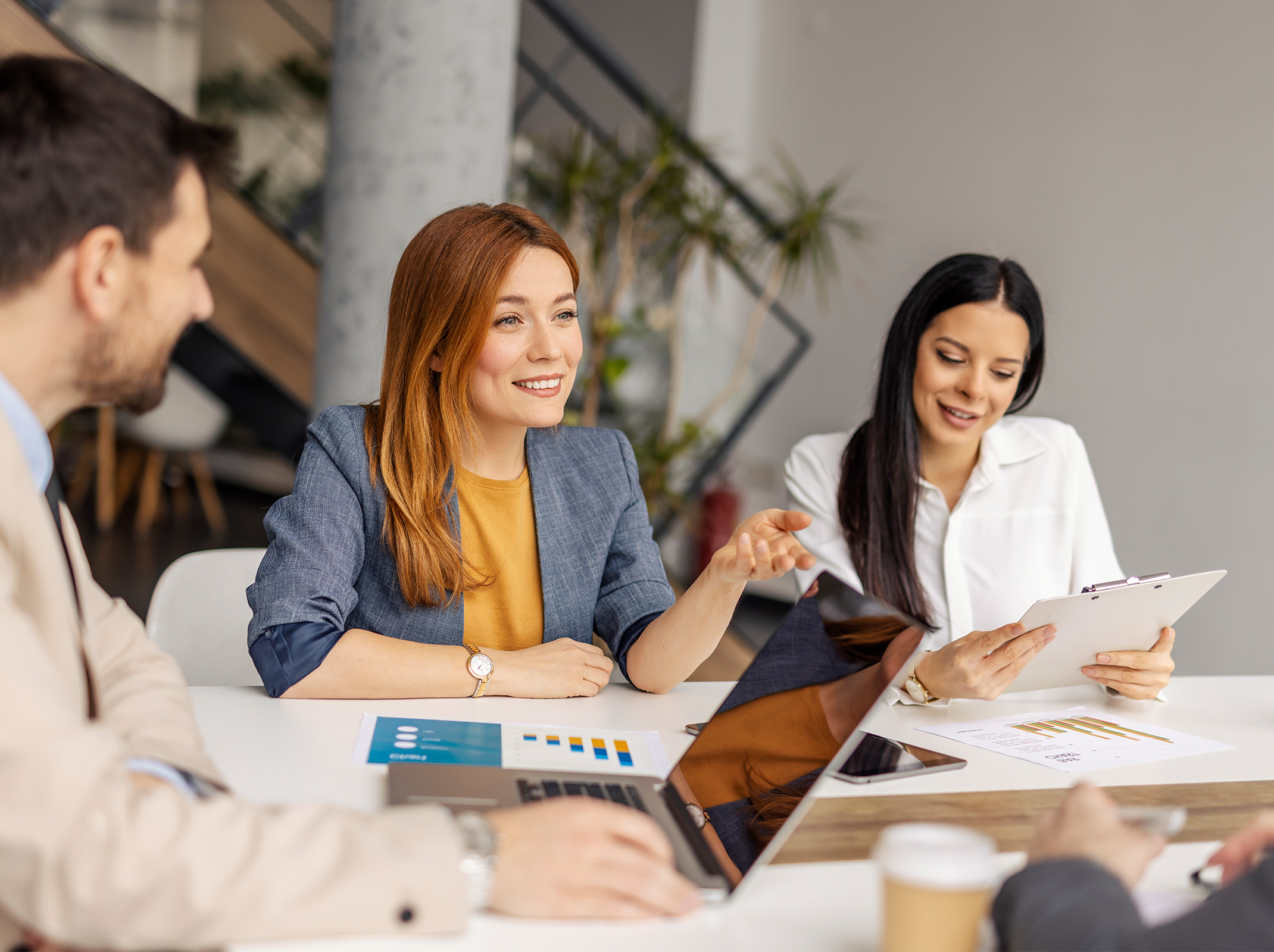 Employees collaborating around a conference table during a workplace discussion