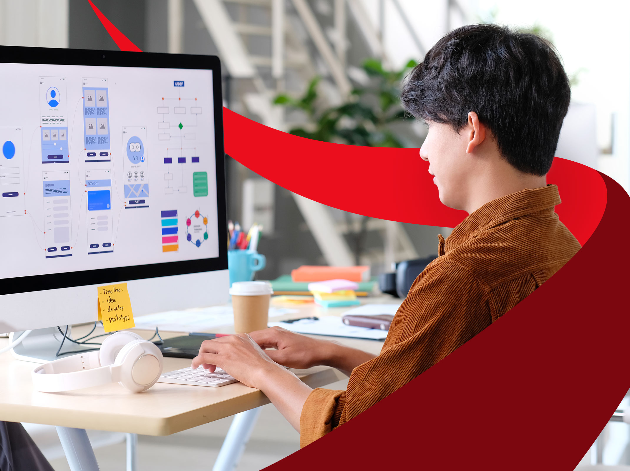 Business professional designing on a large screen in a business setting.