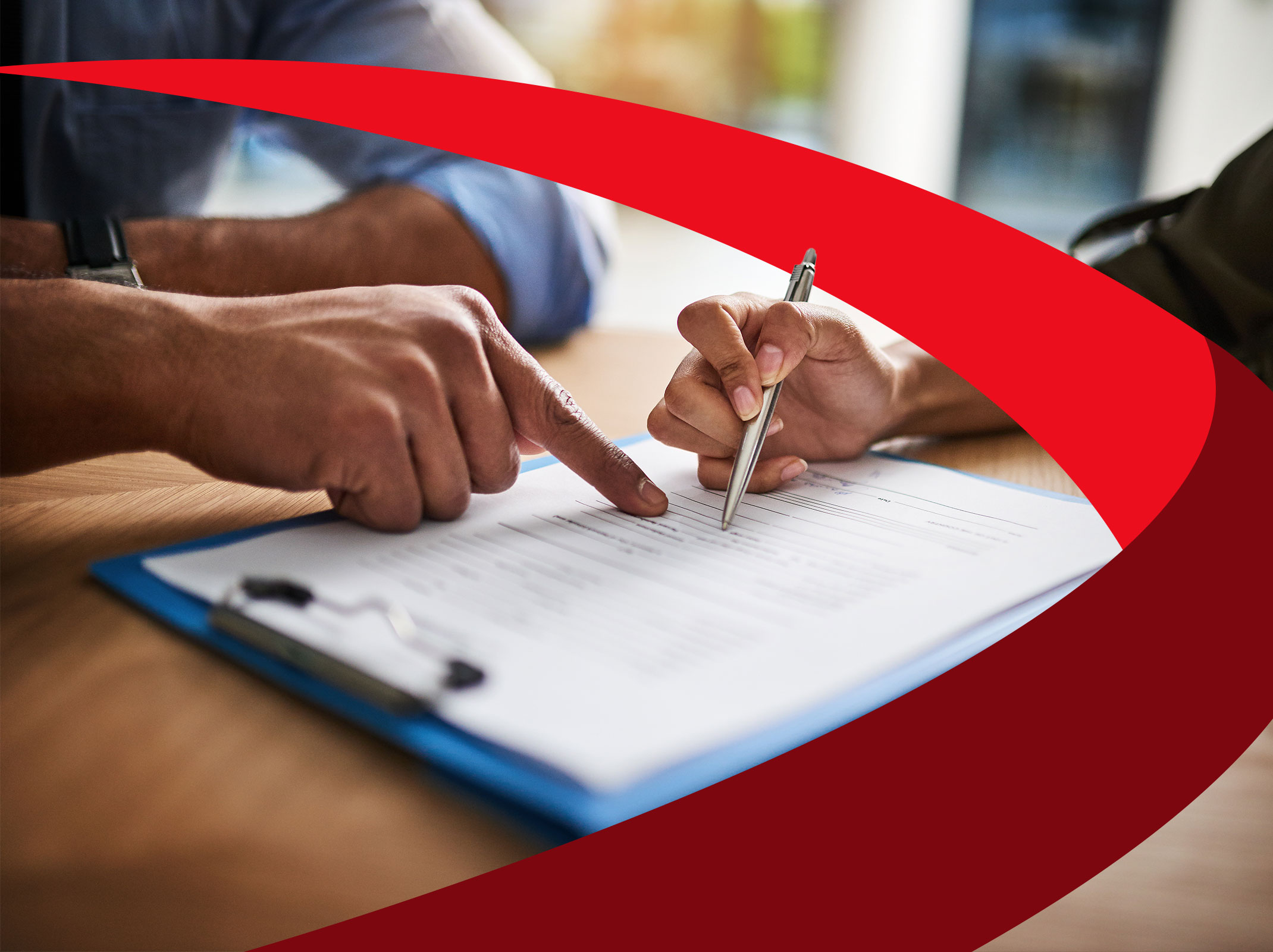 Two business professionals reviewing a document in an office setting.