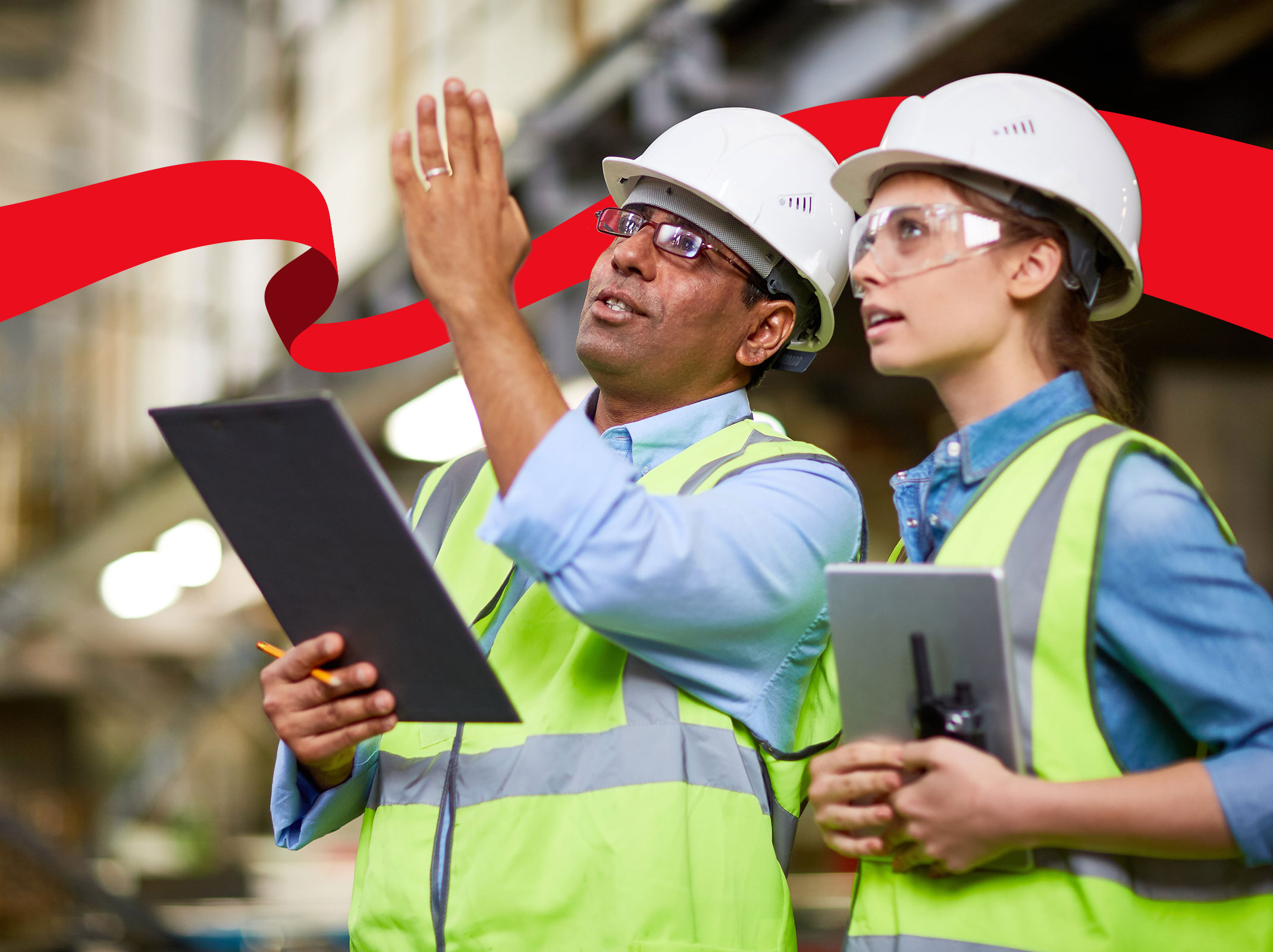 Two construction professionals reviewing  a job site with tablets