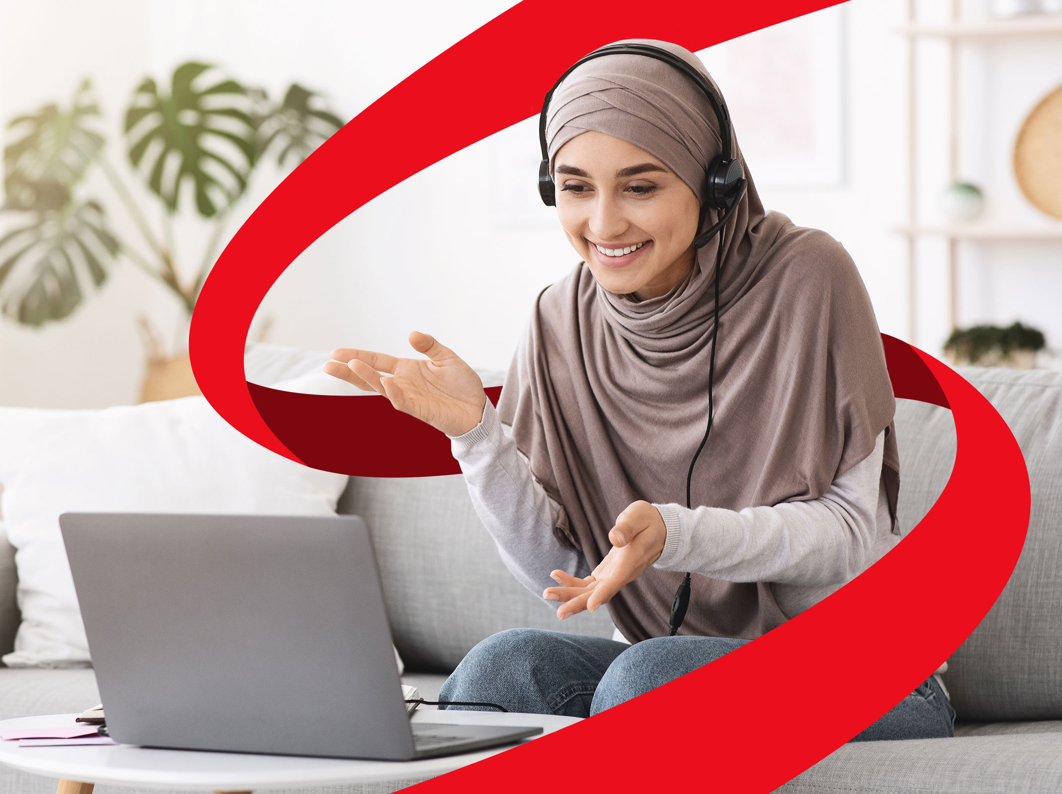 Business professional presenting to a virtual audience with a headset and a laptop.