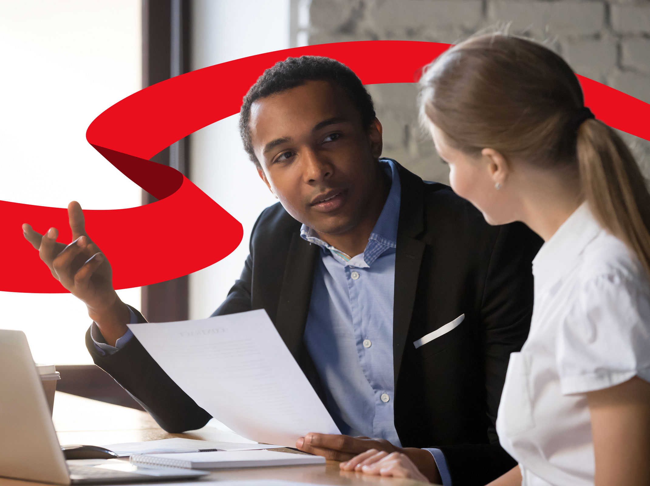 Supervisor reviewing documents with an employee in an office setting