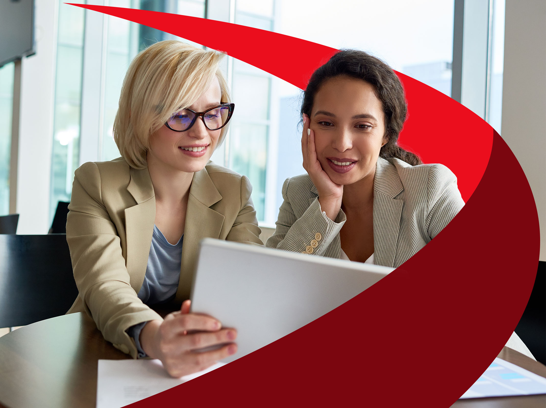 Two female leaders discussing something on a tablet
